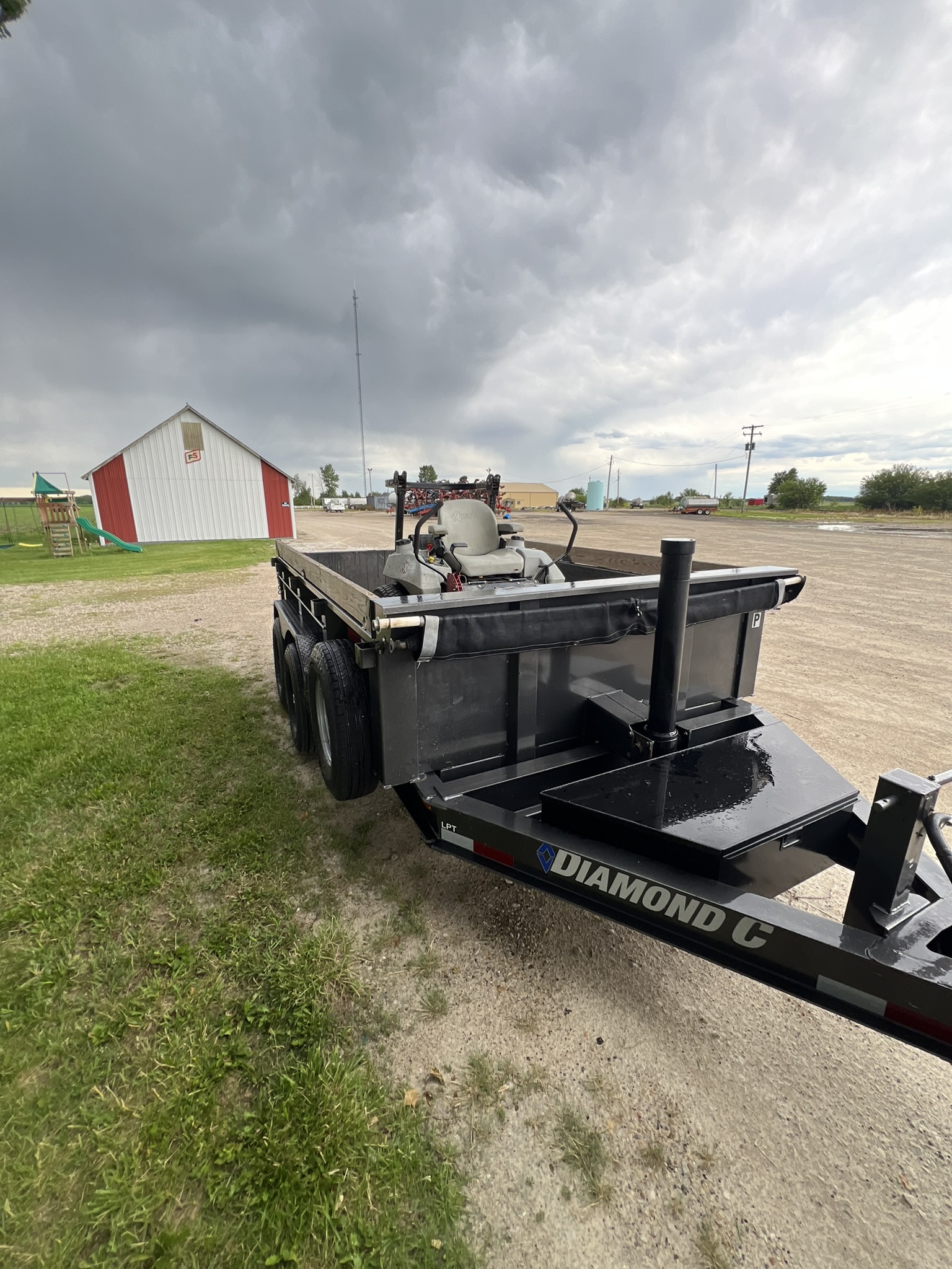 Diamond C dump trailer rear angle showing hydraulic cylinder and Diamond C branding