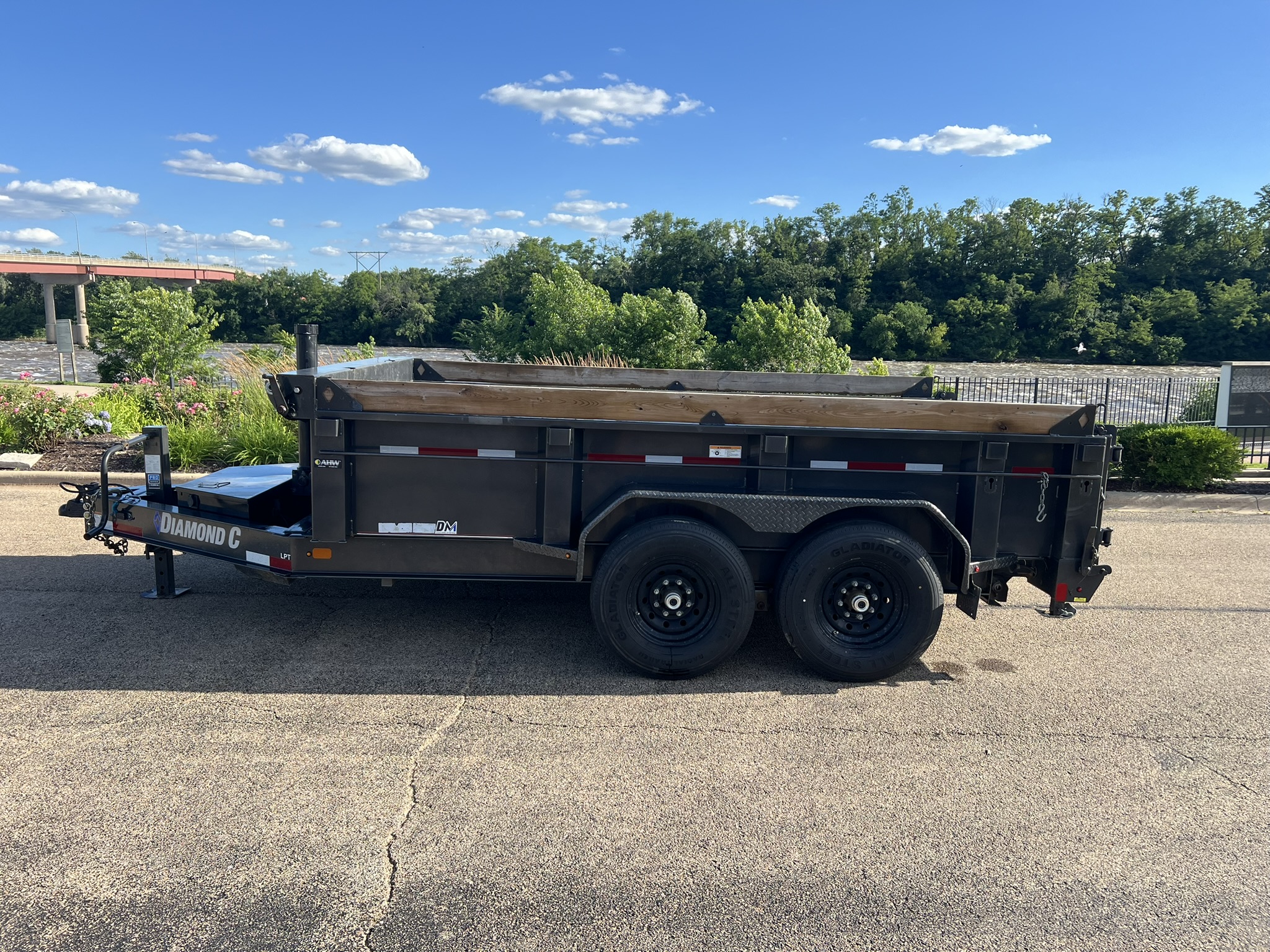 Diamond C DM dump trailer side profile by river - LaSalle County trailer rental