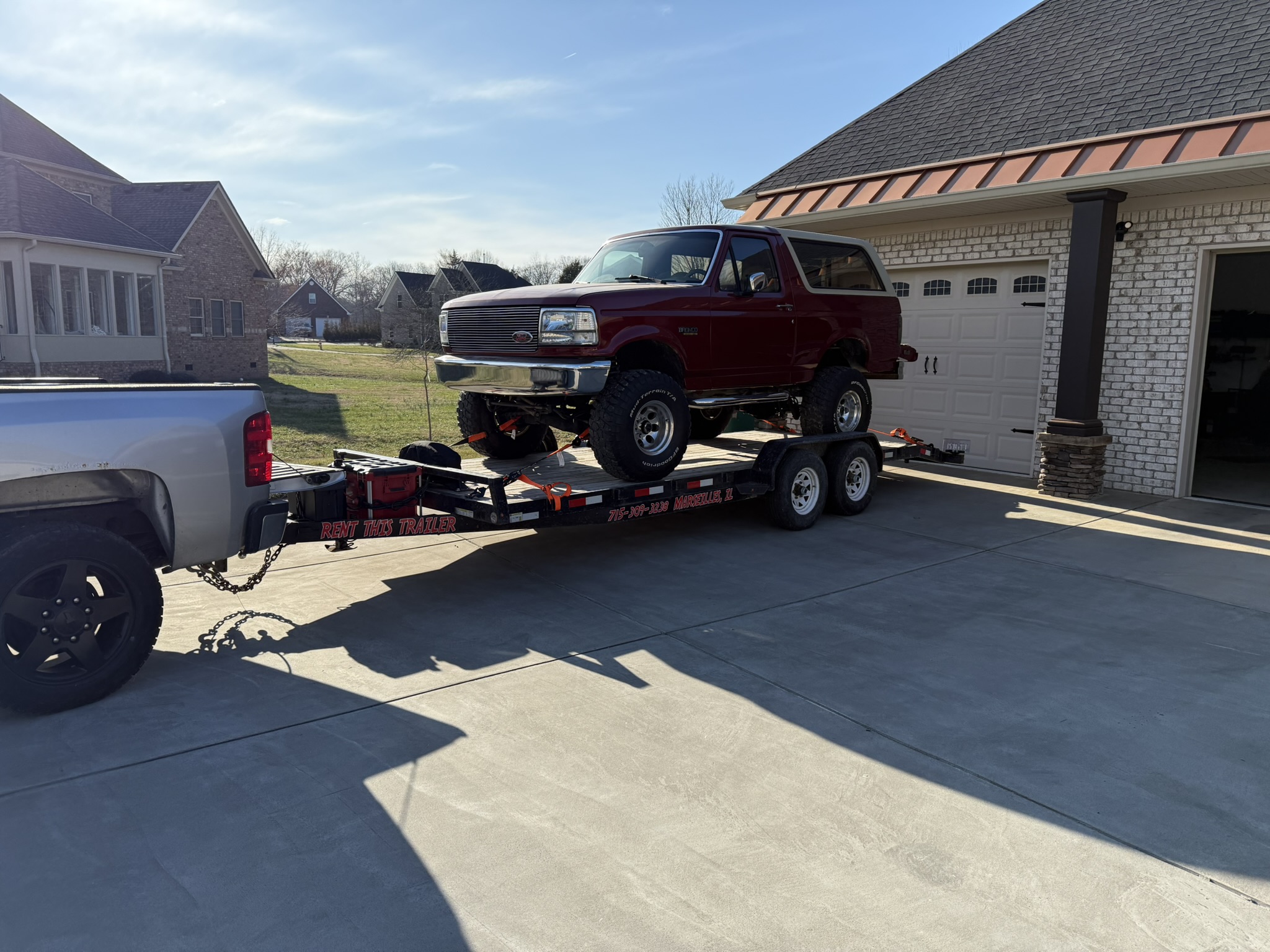 SureTrac trailer hauling lifted Ford Bronco - LaSalle County trailer rental